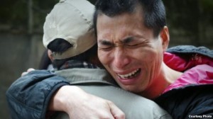 Wu Changlong embraces his father. He was found innocent and released from prison after serving 12 years. (Wu Huaying)