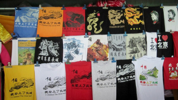 A colorful display of about 20 t-shirts includes such classics as “I climbed the Great Wall,” “I [heart] Beijing,” and shirts featuring dragons, calligraphy, and the visage of Mao Zedong.