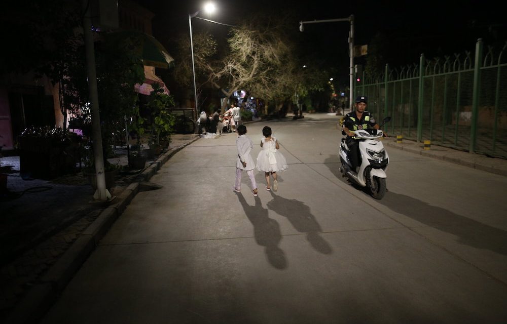 Photo: Local children and police patrol, Kashgar Old City, by Polina Fedorova