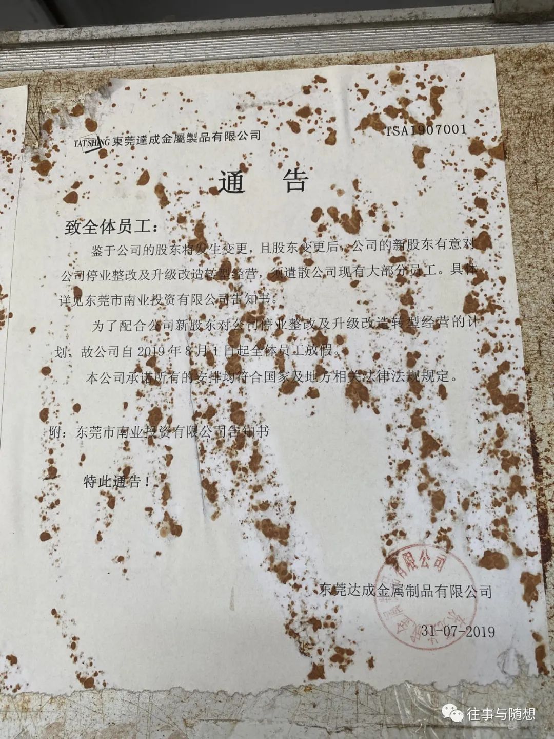 A stained and tattered piece of paper posted to the wall, announcing layoffs at the factory