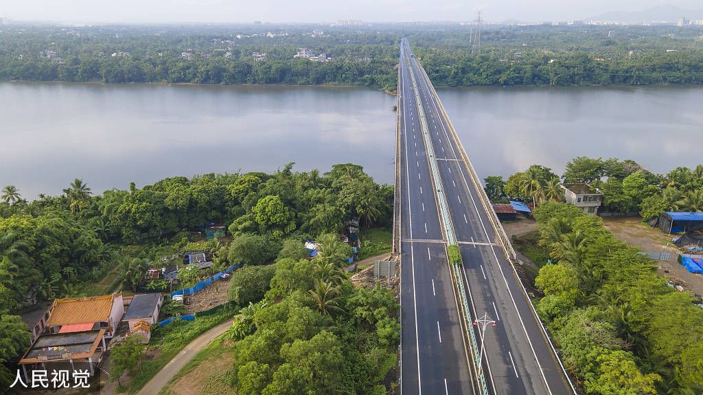 An empty four-lane expressway stretches across a body of water in Sanya, the provincial capital of Hainan.