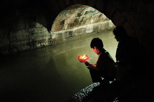 A candle lights a river in Lijiang