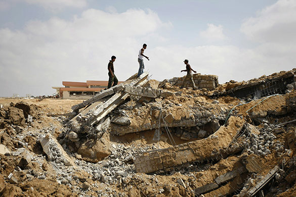 24 Hours in Pictures: Palestinians inspect damage after overnight Israeli air strikes on Rafah