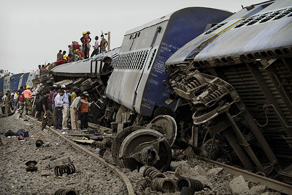 24 Hours in Pictures: Indian rescue workers search for survivors at the site of a train crash 