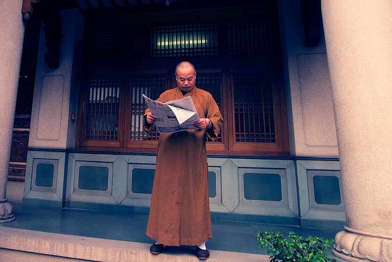 Monk reading Newspaper in Jing'An Temple