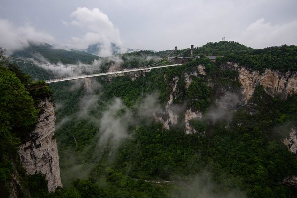 A suspension bridge spans two sides of the flat-topped, heavily forested mountains of Heavenly Pillar in Zhangjiajie National Forest Park, in northwest Hunan Province. The mountains of Heavenly Pillar reportedly inspired the Hallelujah Mountains in the film “Avatar.”