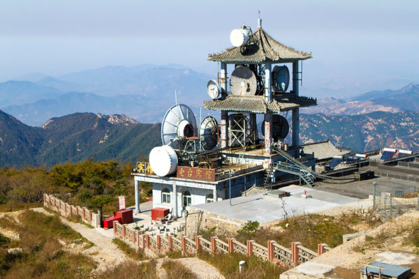 A traditional-style tower encrusted with radio dishes