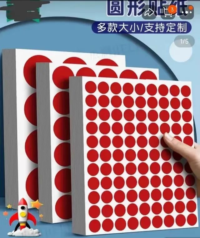 An advertisement features images of stacks of circular red stickers in different sizes on white sheets of paper.