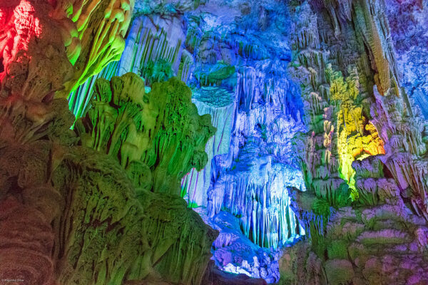 Inside Guilin’s famous “Reed Flute Cave,” colorful spotlights illuminate a fantastical variety of stalactites, stalagmites, and other rock formations.