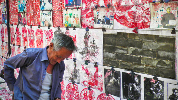 Photo: China, Pingyao – Street vendor of paper cutting art, by Cyprien Hauser